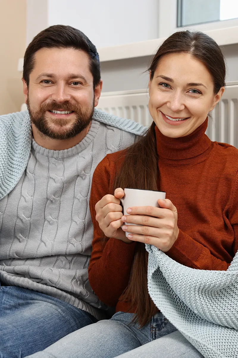Symbolbild-Heizkörper Pärchen vor Heizkörper
