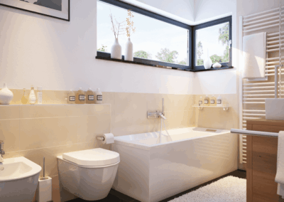 Kleines Badezimmer mit Eckfenster, cremefarbenen Fliesen, Badewanne, Bidet und WC